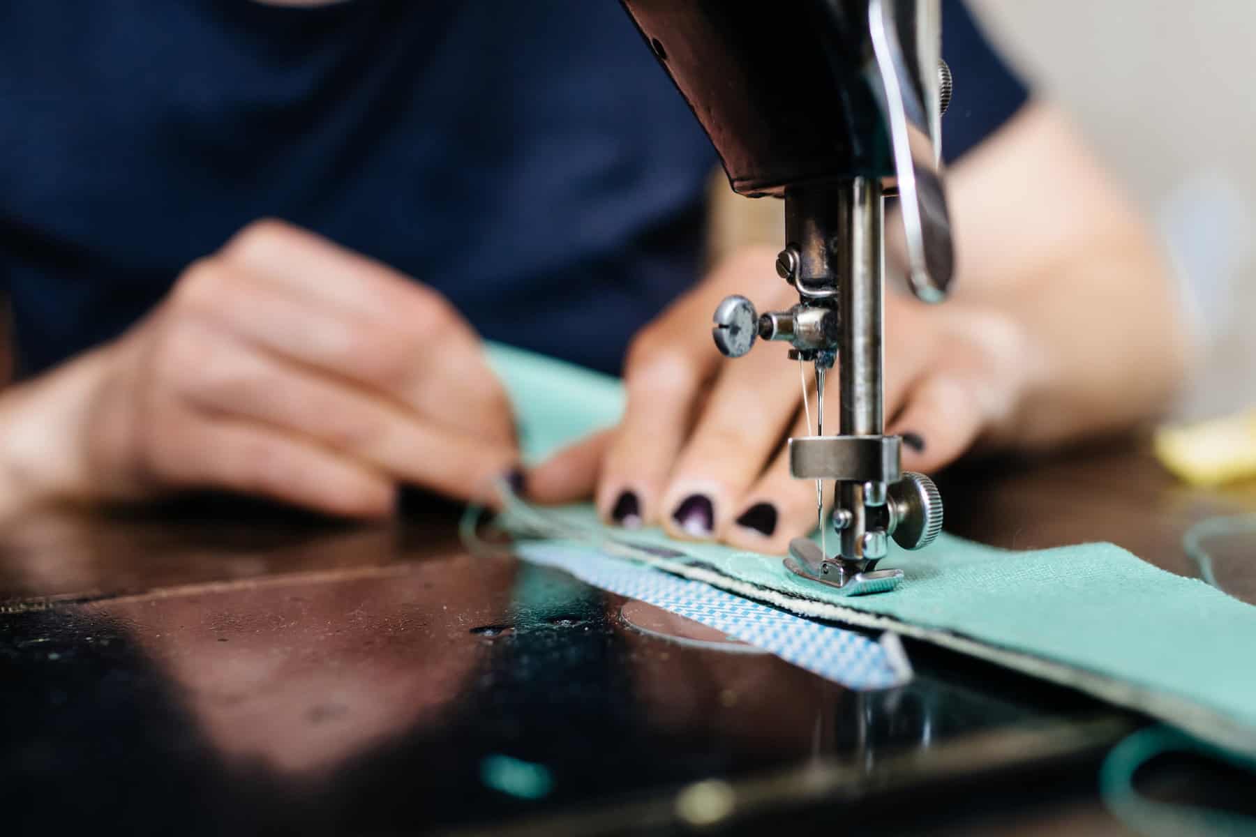 Young Fashion Designer Working On Sewing Machine